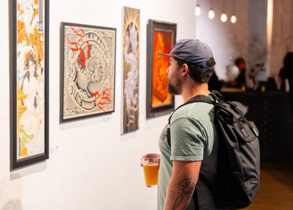 Gallery visitor looking at art on the wall